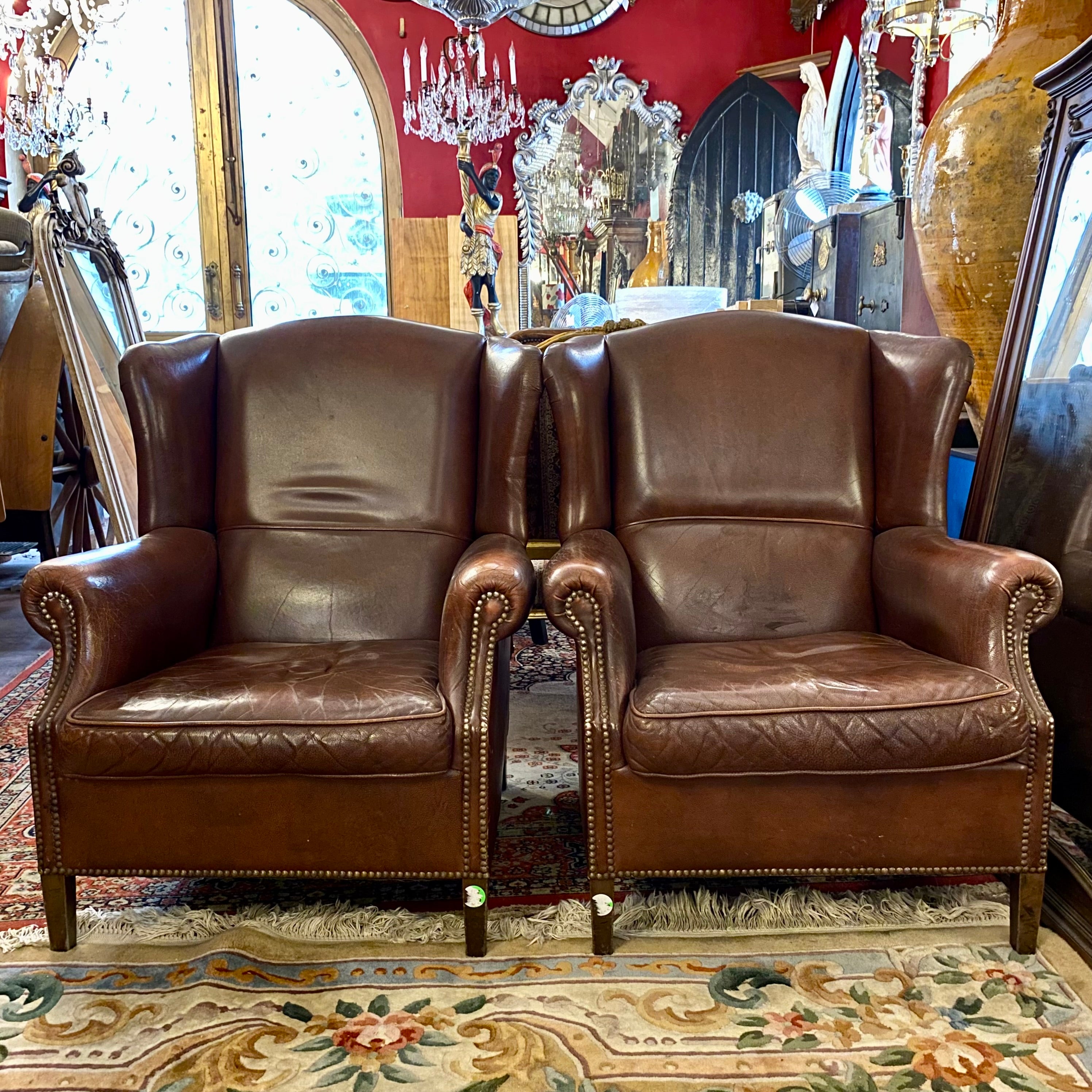 A pair of Dark Leather armchairs - SOLD